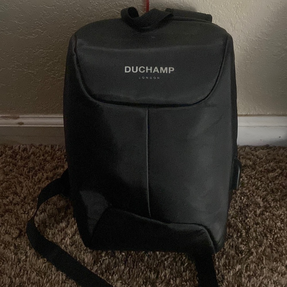 Used Duchamp backpack, Has charging port, for tablets or small laptops.